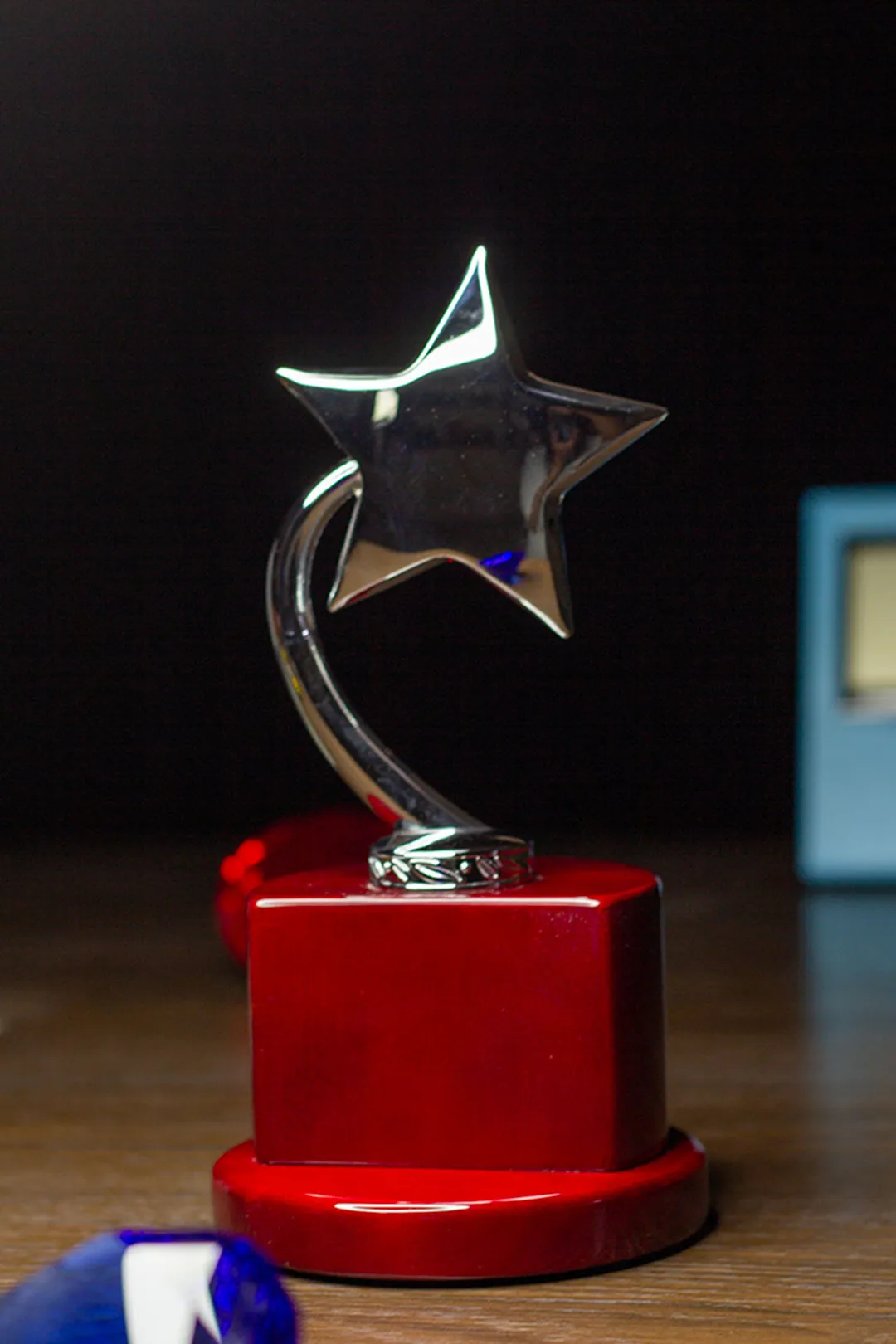 Polished Gold Rising Star Trophy on Crimson Wood Base